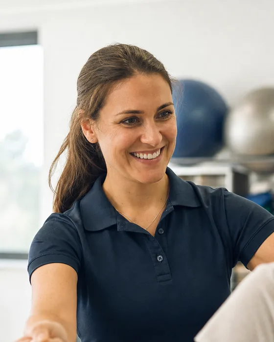 A physical therapist guiding a patient through a resistance band exercise