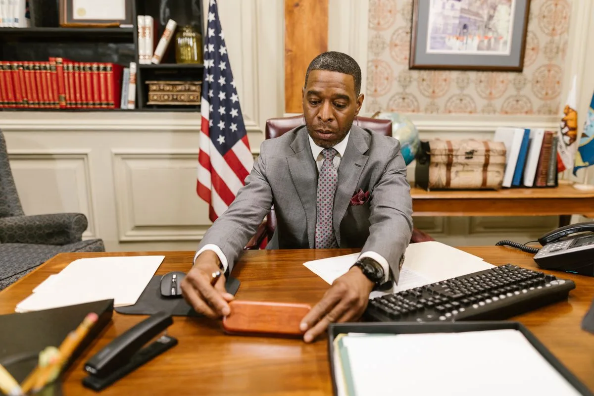 Attorney working at a desk with law books behind him