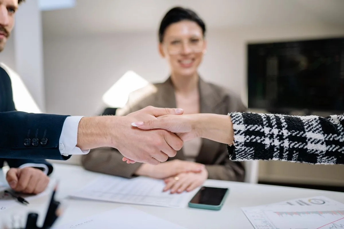 Advisor and business owner shaking hands